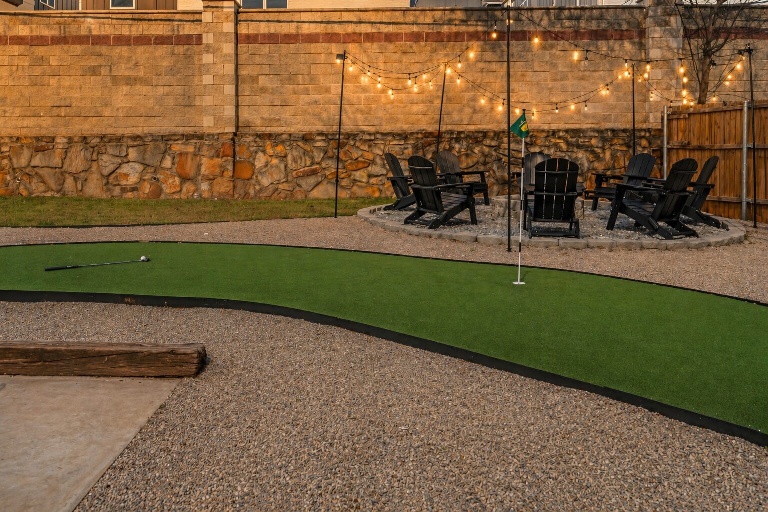 Backyard at golden hour with putting green and fire pit